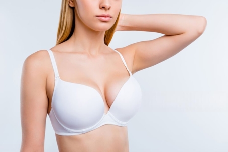 A woman wearing a white bra is featured as an image option for a webpage. This image may be associated with breast augmentation or a breast lift.